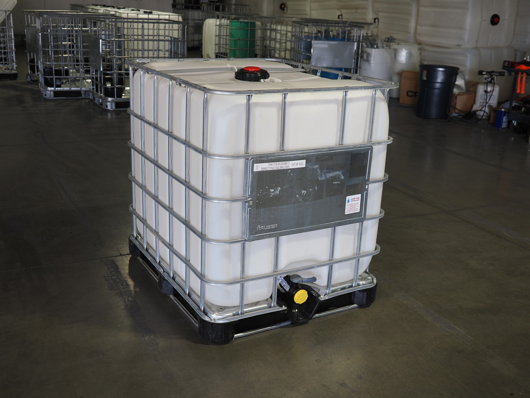 Actual finished rebottled IBC at Clean Tank with cage, bottle, pallet, lid, faceplate and valve visible