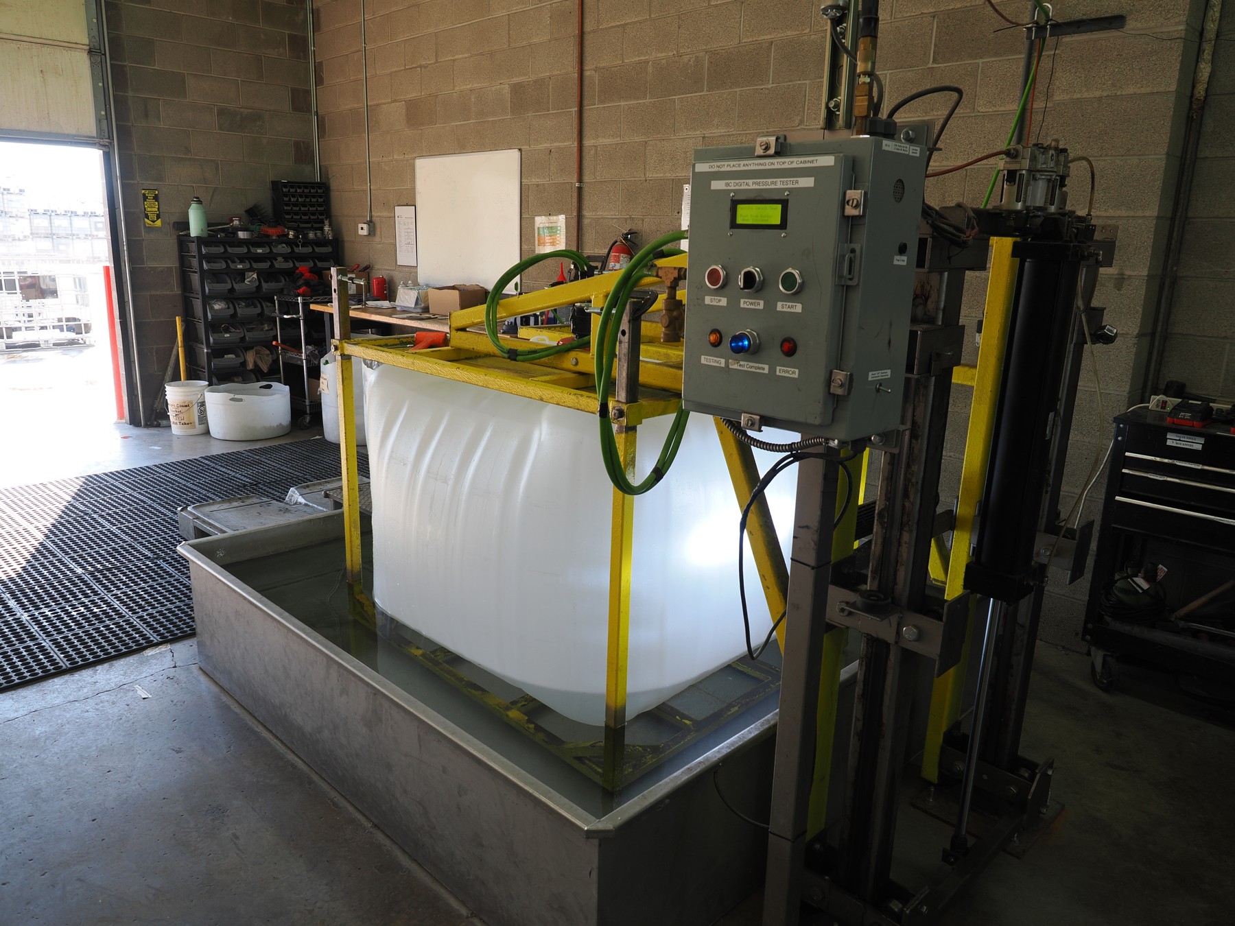IBC bottle in Clean Tank's pressure-based leakproofness testing fixture