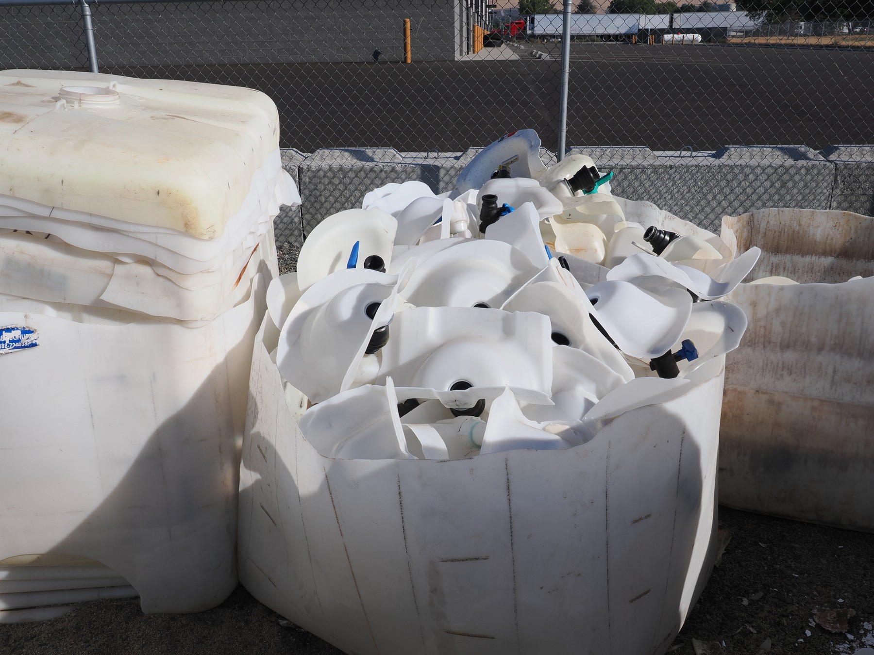 Cut HDPE IBC bottle components collected for material recycling